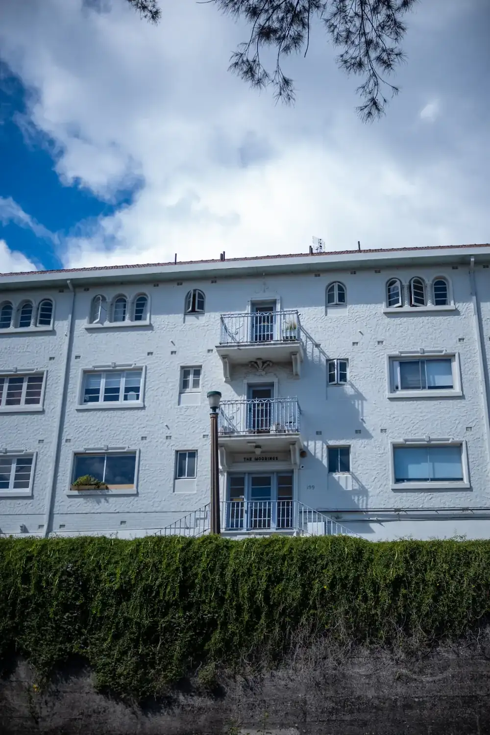 A white apartment building with balconies